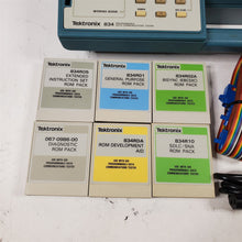 Load image into Gallery viewer, Tektronix 834 Programmable Data Communications Tester w/ 6 Rom Packs &amp; 2 Cables